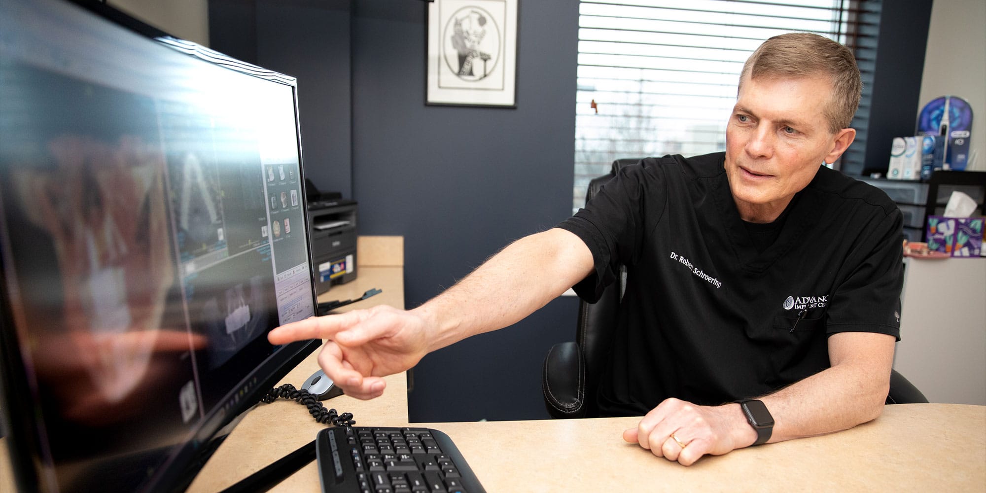 doctor going over dental procedure information with patient within the dental center