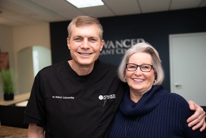 patient and doctor smiling together after patient's treatment within the dental center